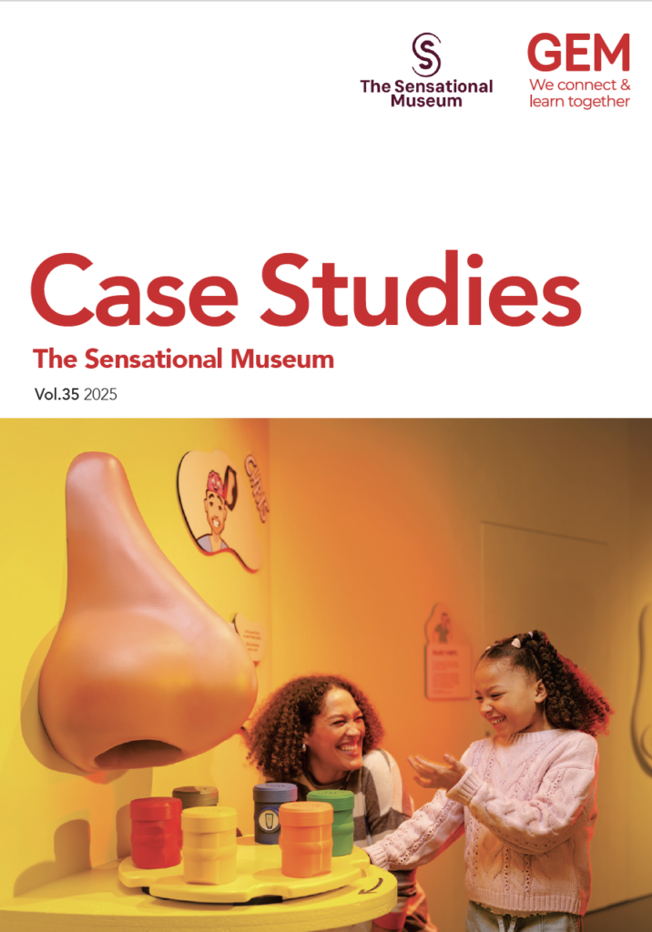 The front cover of the GEM / TSM Case study. A woman and child explore coloured objects in a yellow room. A giant model of a nose hangs on a wall to the left of the image.